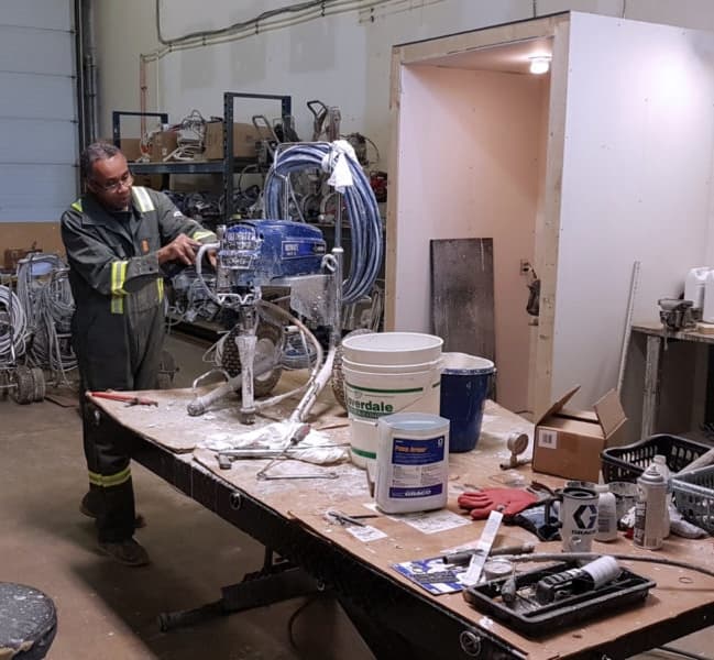 Technician repairing a paint sprayer